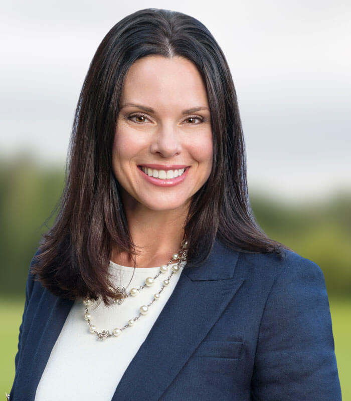 headshot of Rebecca Thomas in a white shirt and blue blazer