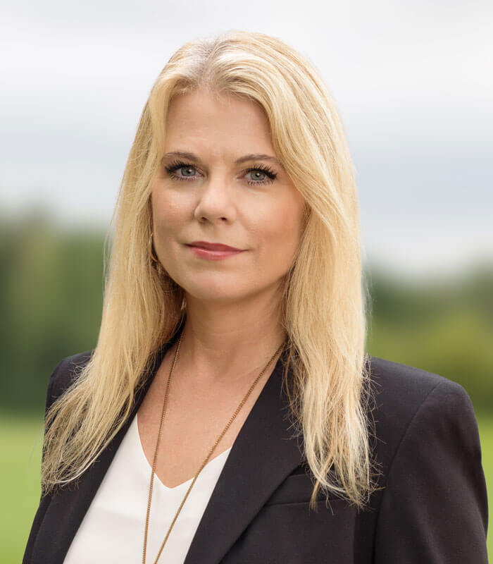 Stacy Lopez in a black blazer and white blouse