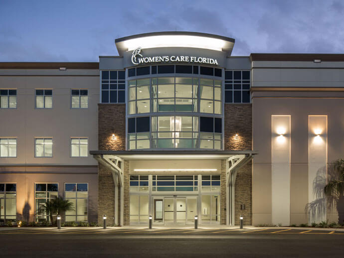 women's care Florida building at night